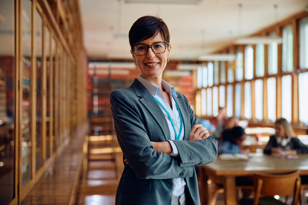Confident female professor in the classroom looking at camera.